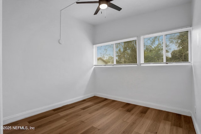 unfurnished room with ceiling fan and hardwood / wood-style floors