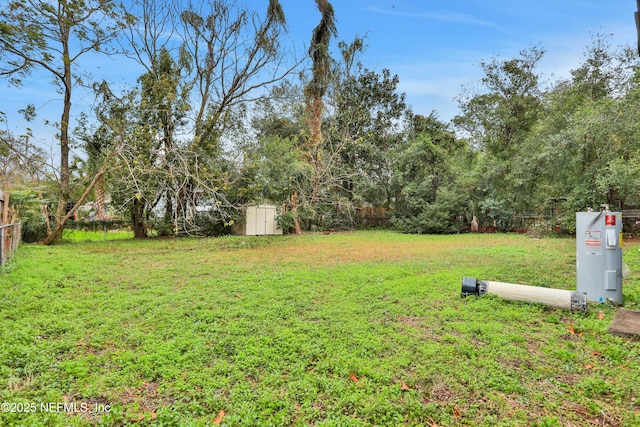 view of yard featuring a shed and water heater