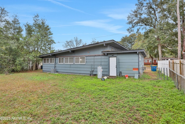 rear view of house featuring a yard