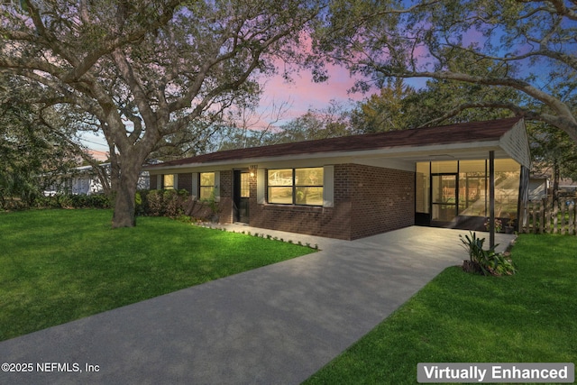 view of front facade featuring a yard and a carport