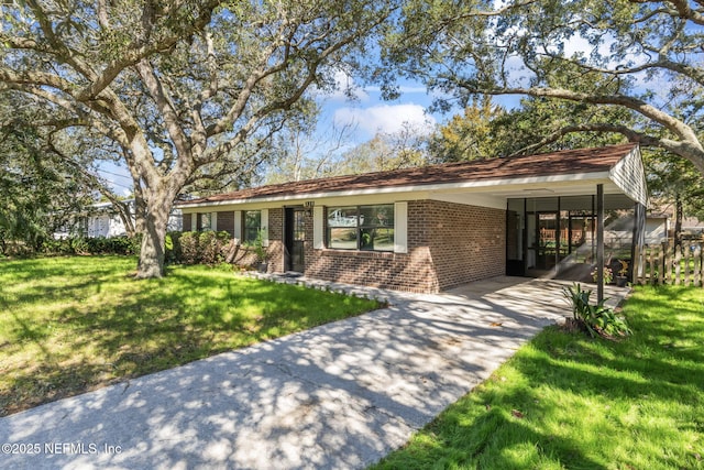 single story home with a front yard and a carport