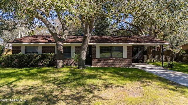 single story home featuring a front lawn and a carport