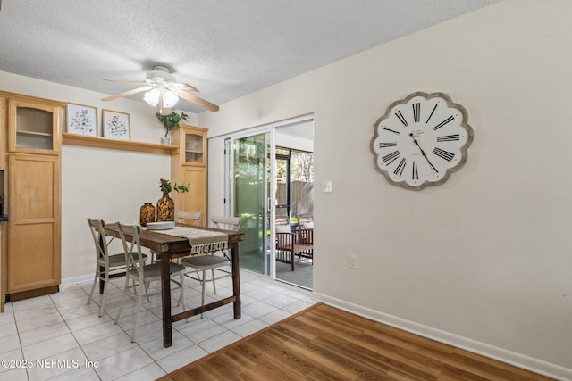 dining space with light tile patterned flooring, a textured ceiling, and ceiling fan