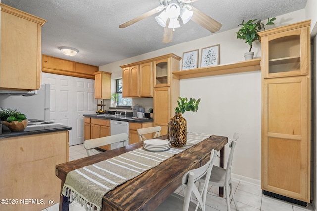 kitchen featuring white appliances, a textured ceiling, light brown cabinetry, light tile patterned floors, and sink