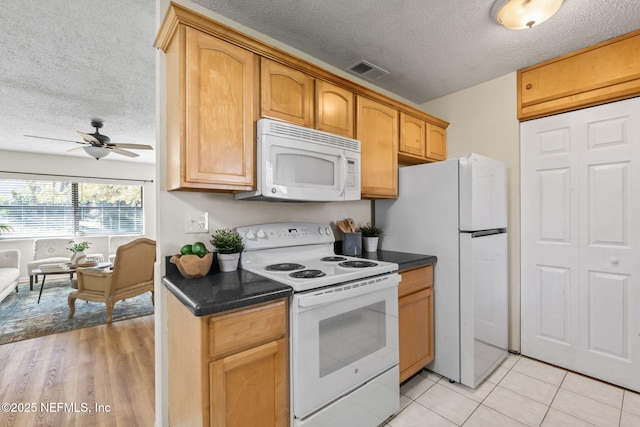 kitchen featuring white appliances, ceiling fan, a textured ceiling, and light tile patterned floors