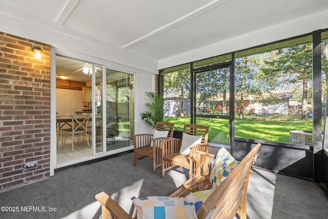 sunroom featuring ceiling fan