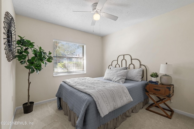 carpeted bedroom featuring a textured ceiling and ceiling fan