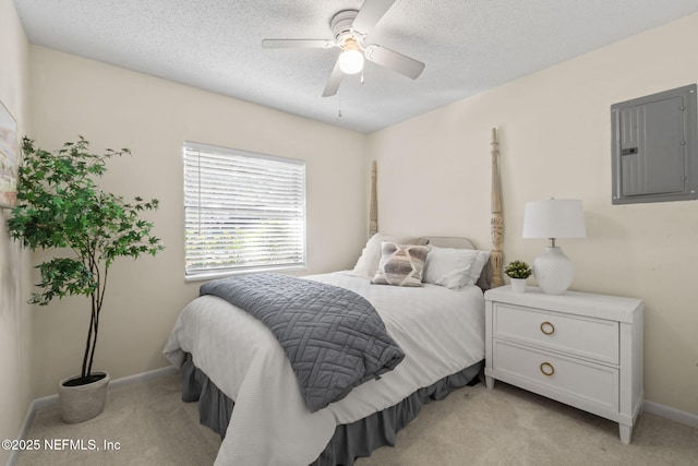 carpeted bedroom featuring a textured ceiling, ceiling fan, and electric panel