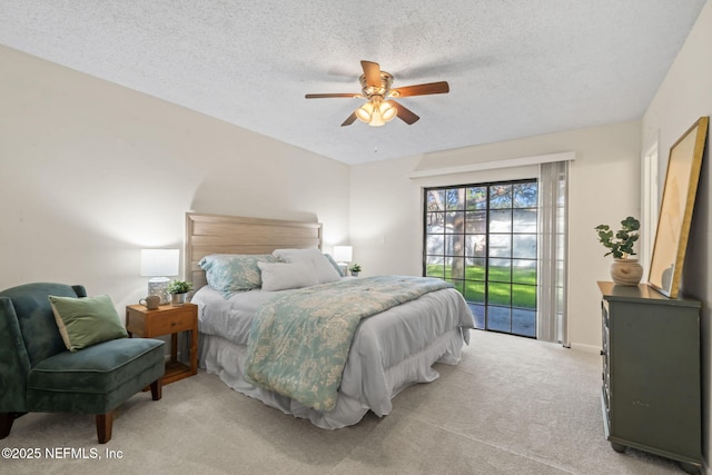 carpeted bedroom featuring ceiling fan, a textured ceiling, and access to exterior