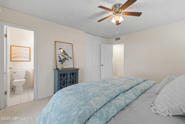 carpeted bedroom with ceiling fan, connected bathroom, and a closet