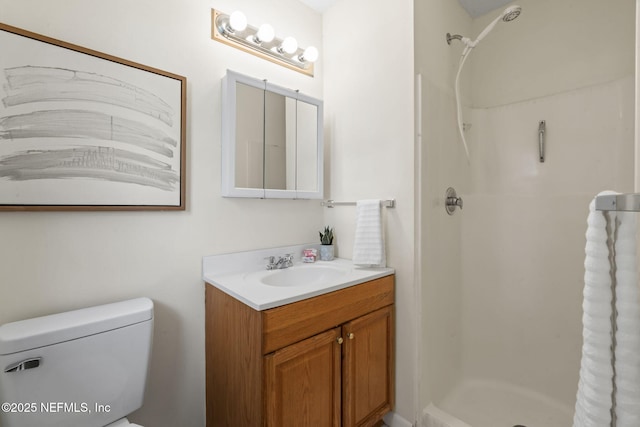 bathroom featuring walk in shower, vanity, and toilet