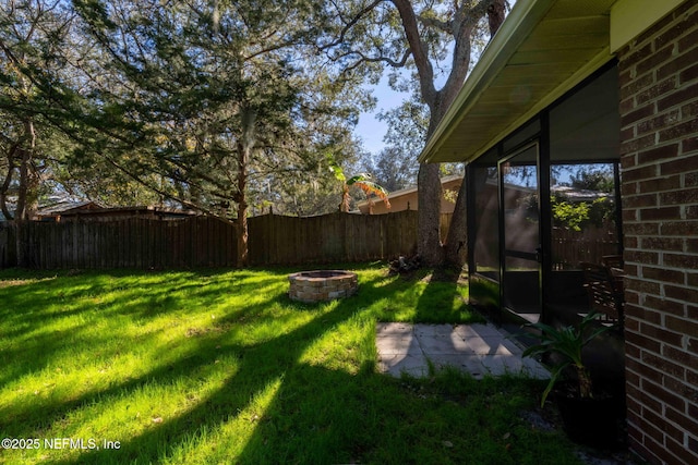 view of yard with a fire pit