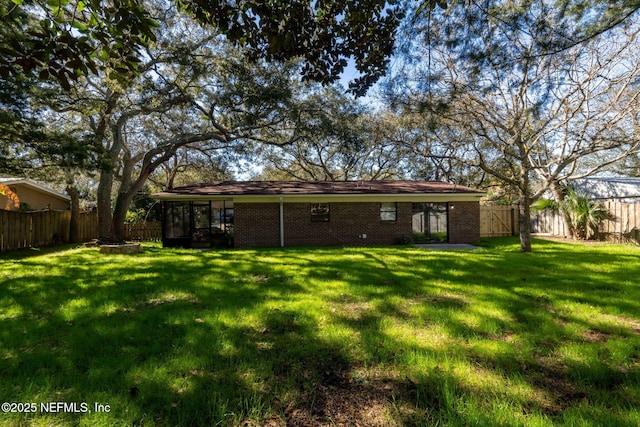 rear view of house with a yard