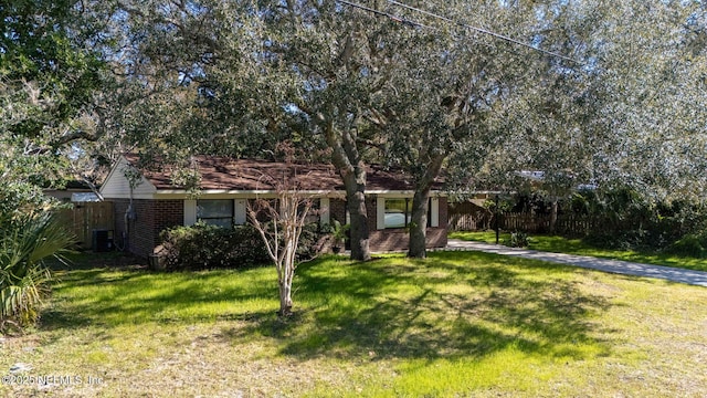 view of front of property with a front yard and cooling unit