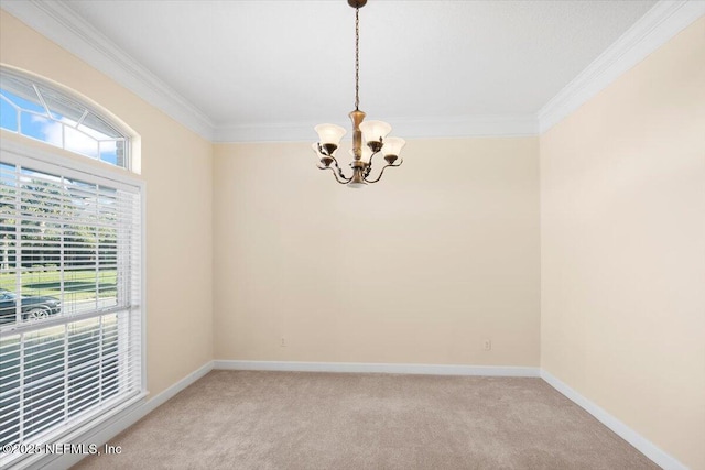 carpeted empty room featuring a chandelier and crown molding