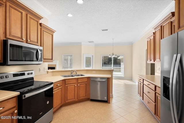 kitchen featuring sink, stainless steel appliances, a notable chandelier, pendant lighting, and ornamental molding