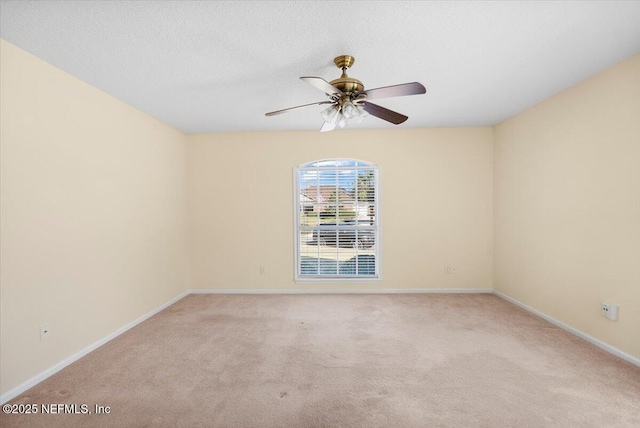 unfurnished room featuring light colored carpet and ceiling fan