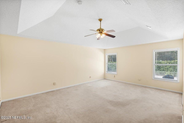 carpeted empty room featuring ceiling fan and a textured ceiling