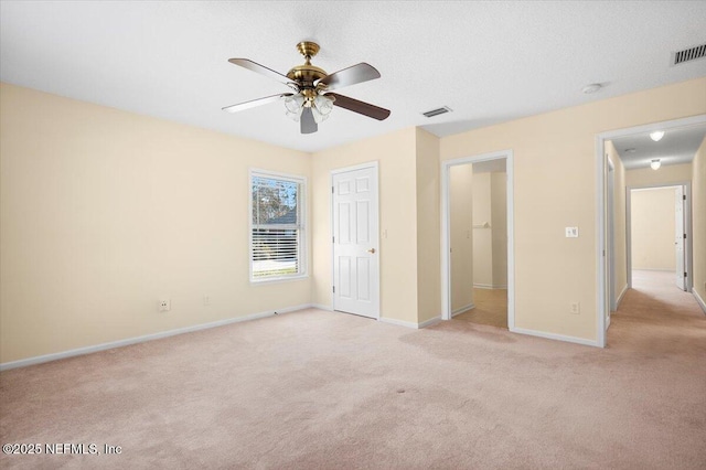 unfurnished bedroom featuring light carpet and ceiling fan