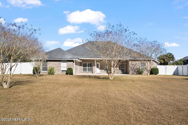 back of property featuring a patio area and a lawn