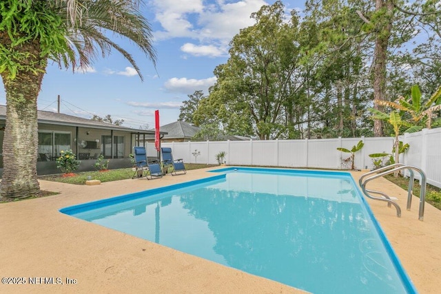 view of swimming pool with a sunroom and a patio