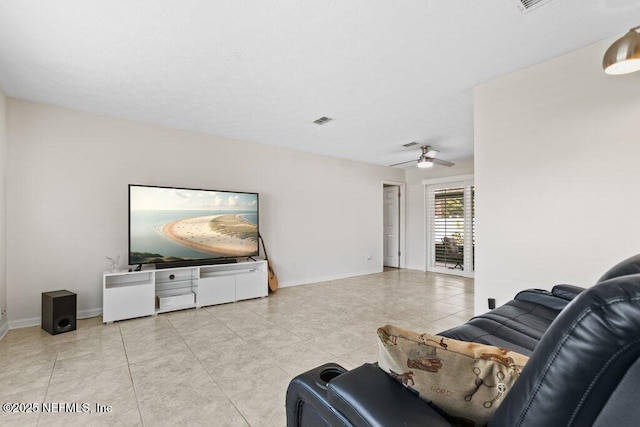 tiled living room featuring ceiling fan