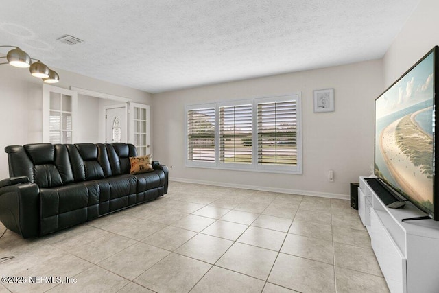 living room featuring light tile patterned floors and a textured ceiling