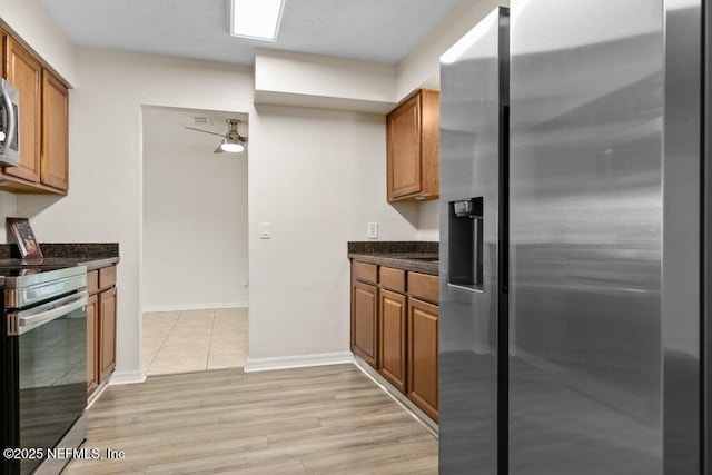 kitchen with light wood-type flooring and appliances with stainless steel finishes