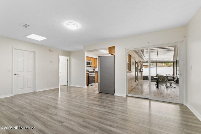 unfurnished living room featuring light hardwood / wood-style flooring