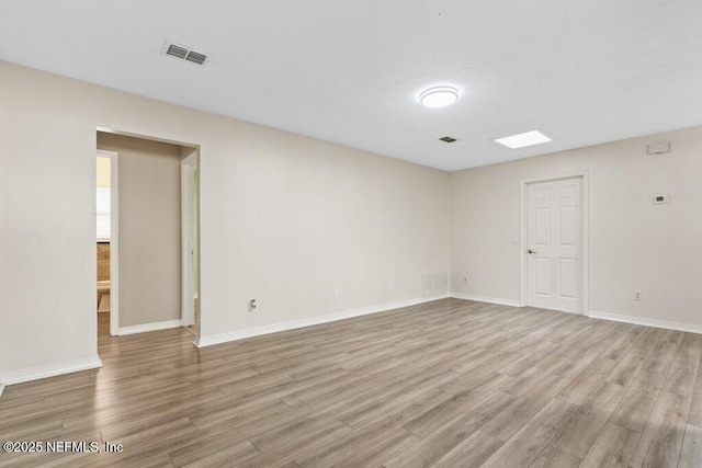 empty room with light hardwood / wood-style flooring