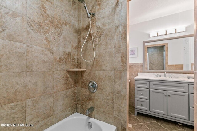 bathroom featuring vanity, tile walls, and tiled shower / bath