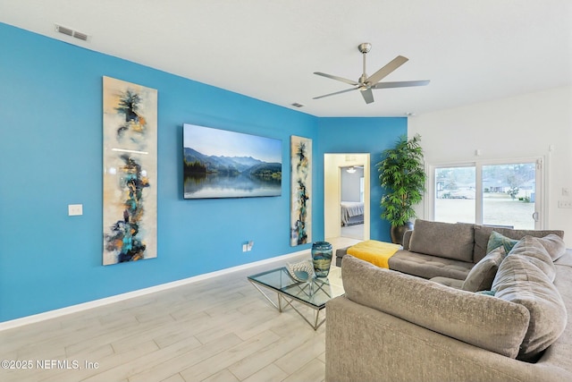 living room featuring ceiling fan and light hardwood / wood-style floors