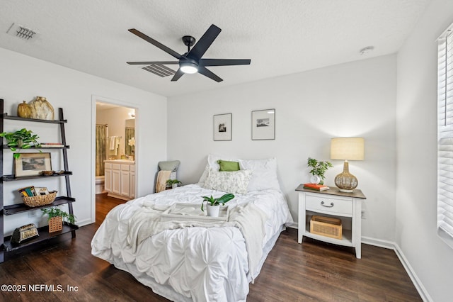 bedroom featuring ceiling fan, ensuite bath, dark hardwood / wood-style floors, and a textured ceiling