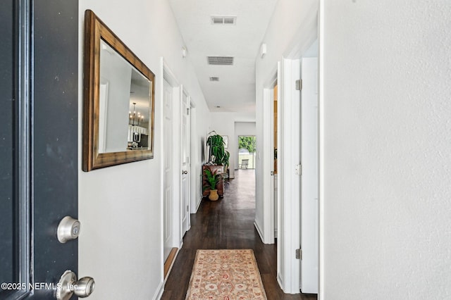 corridor featuring dark wood-type flooring