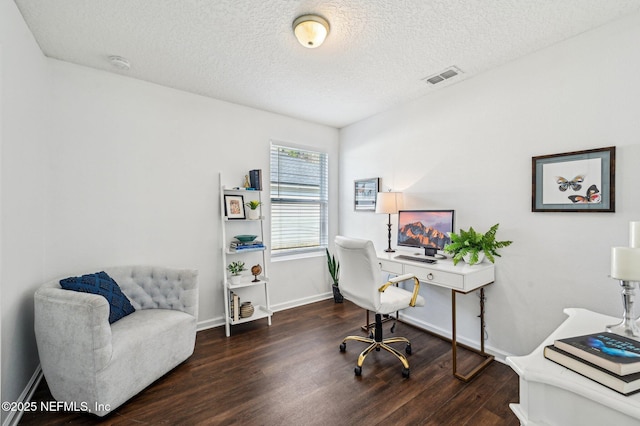 home office with dark hardwood / wood-style flooring and a textured ceiling