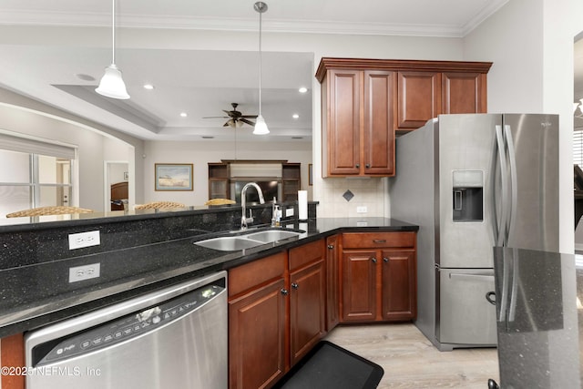 kitchen with decorative backsplash, stainless steel appliances, ceiling fan, sink, and pendant lighting