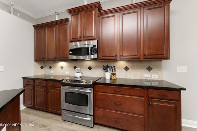 kitchen with backsplash, ornamental molding, light wood-type flooring, and appliances with stainless steel finishes