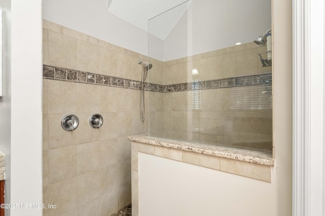 bathroom with a tile shower