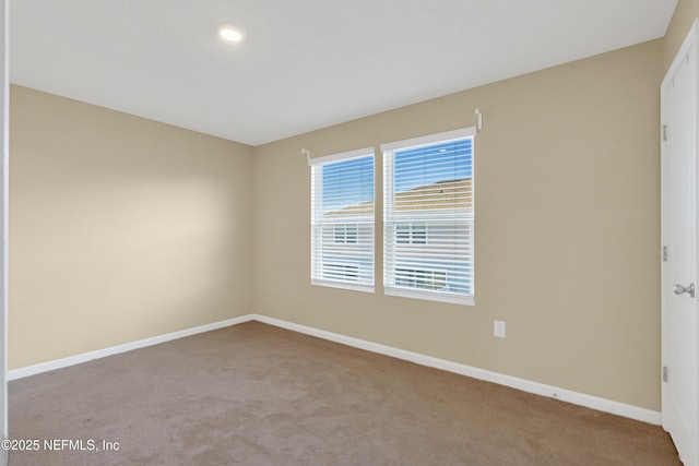 unfurnished room with light colored carpet