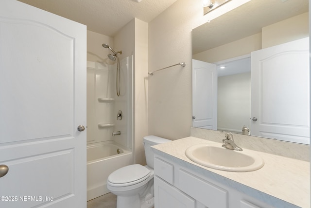 full bathroom with shower / bathing tub combination, vanity, a textured ceiling, and toilet