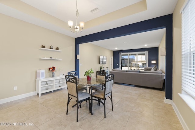 dining area with a chandelier and light tile patterned floors