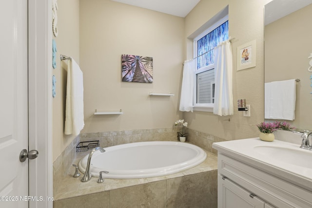 bathroom with vanity and tiled bath