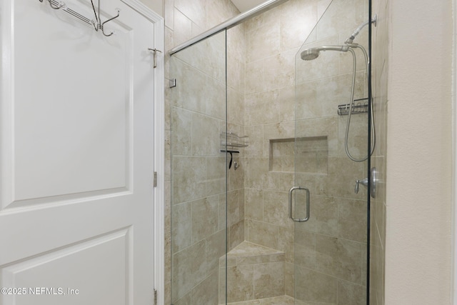 bathroom with a shower with door