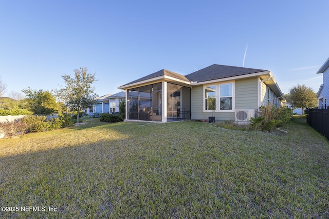 view of front facade with a front lawn, a sunroom, and ac unit