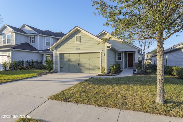 view of front of house featuring a garage and a front lawn