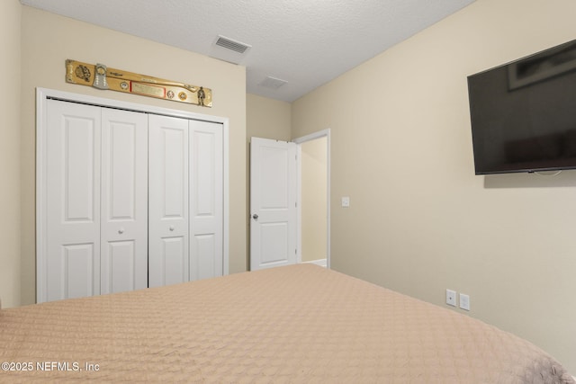 unfurnished bedroom with a textured ceiling and a closet