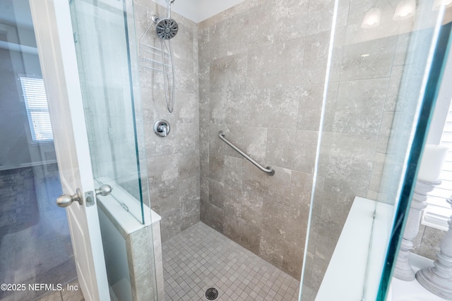 bathroom with a tile shower