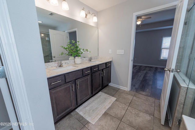 bathroom with walk in shower, vanity, tile patterned floors, and ceiling fan