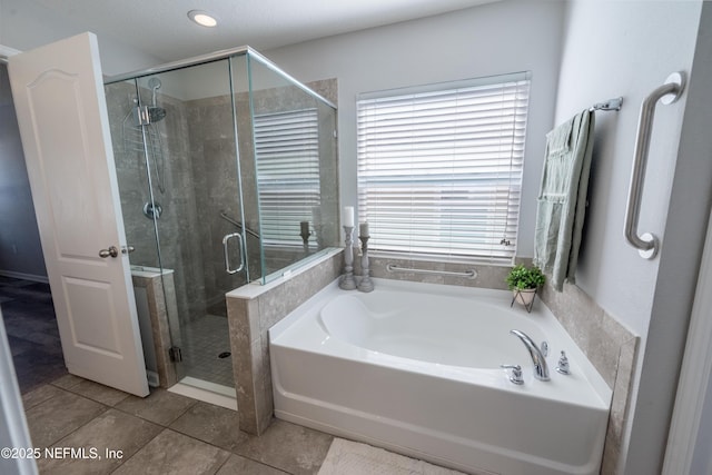 bathroom featuring tile patterned floors and separate shower and tub