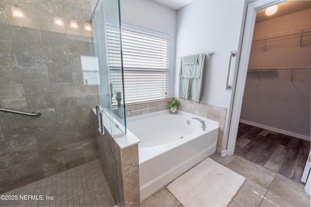 bathroom featuring separate shower and tub